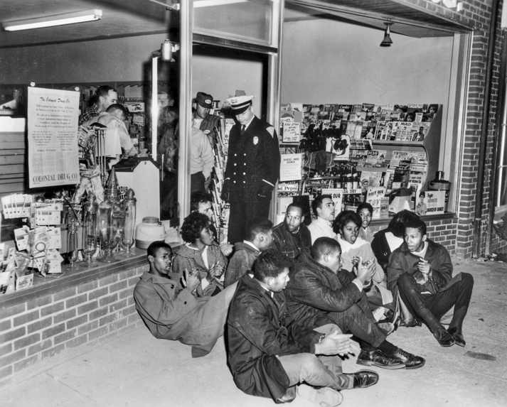 Demonstrators block the entrance to Colonial Drug Store in Chapel Hill in 1964 to protest its policy of serving only whites. (North Carolina Collection, University of North Carolina at Chapel Hill Library)