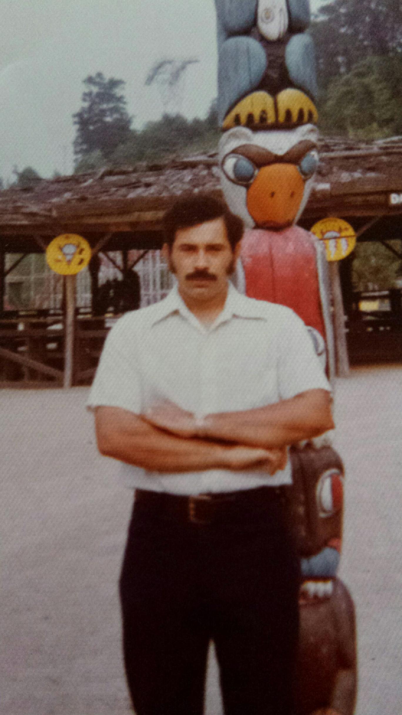 Hughie Maynor stands in front of a totem pole near Cherokee, North Carolina in 1974. (Image courtesy of Hughie Maynor)
