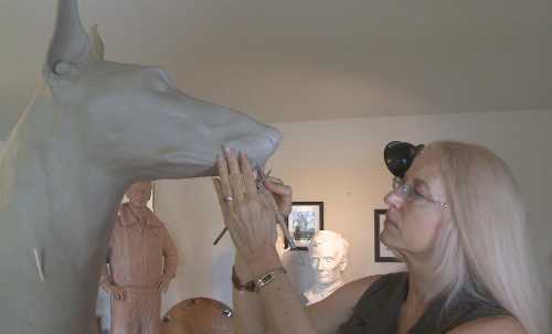 Sculptor Paula Slater of Hidden Valley Lake, Calif., working on one of the sculpture for a national monument to honor dogs that have served in wars from Word War II to the present. Courtesy of Paula Slater/Lake County News.