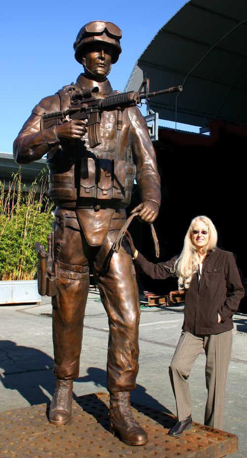 Sculptor Paula Slater of Hidden Valley Lake, Calif., with the statue of a soldier she created for a national monument to honor dogs that have served in wars from Word War II to the present. Courtesy of Paula Slater/Lake County News